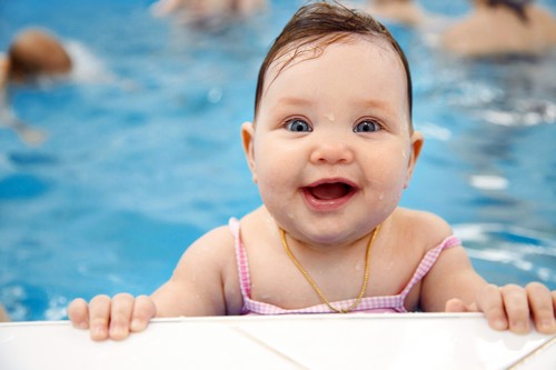 Portrait of little baby girl swimming  in swimming pool