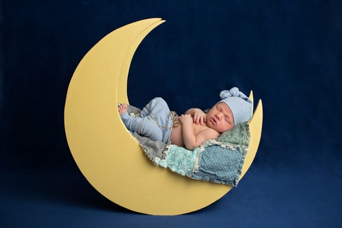 Newborn Boy Sleeping on the Moon