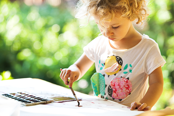 Child Painting in the garden